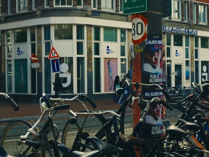 Bicycles parked outside a corner building in Amsterdam