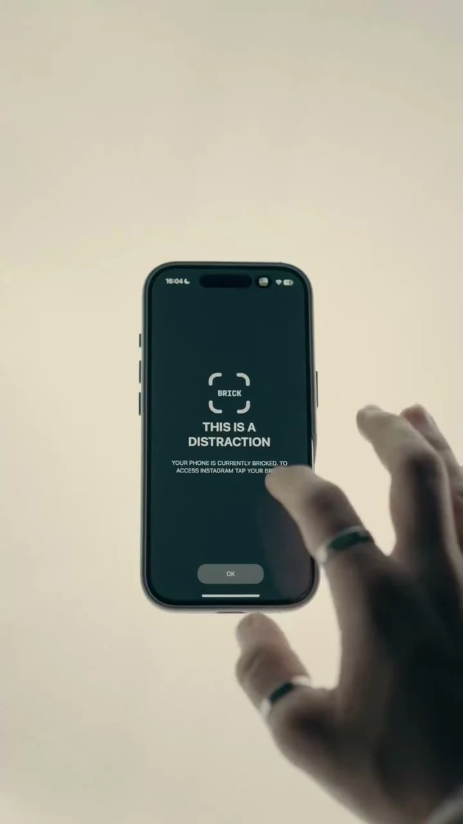 A phone showing the Brick app in a hand