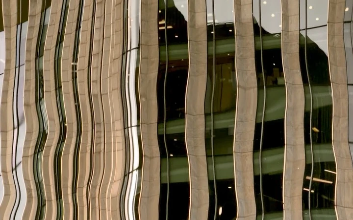 Cream and dark windows bent into waves by reflections