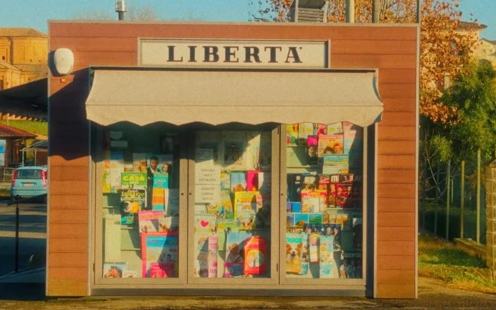 A small bookshop facade with a green door and an orange frame
