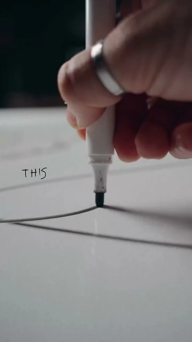 A hand drawing notes on paper