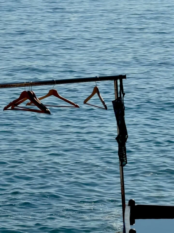 A swimmer diving from a small platform over the sea