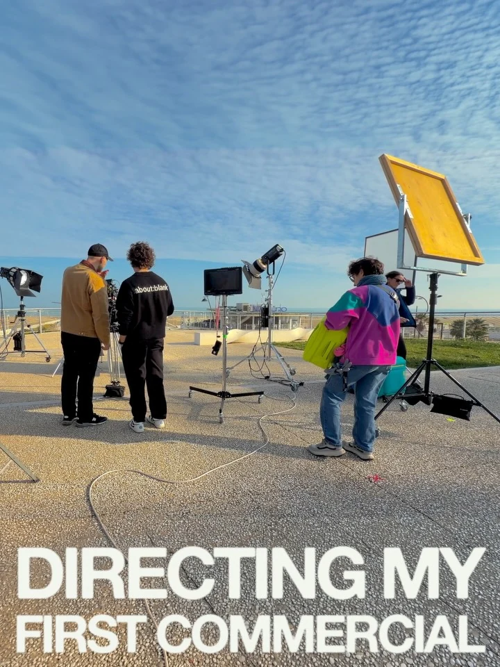 The crew working outdoors with a large yellow light modifier