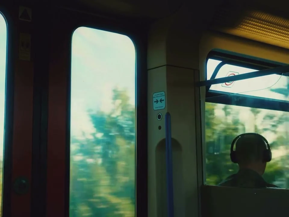 A passenger silhouetted beside train windows