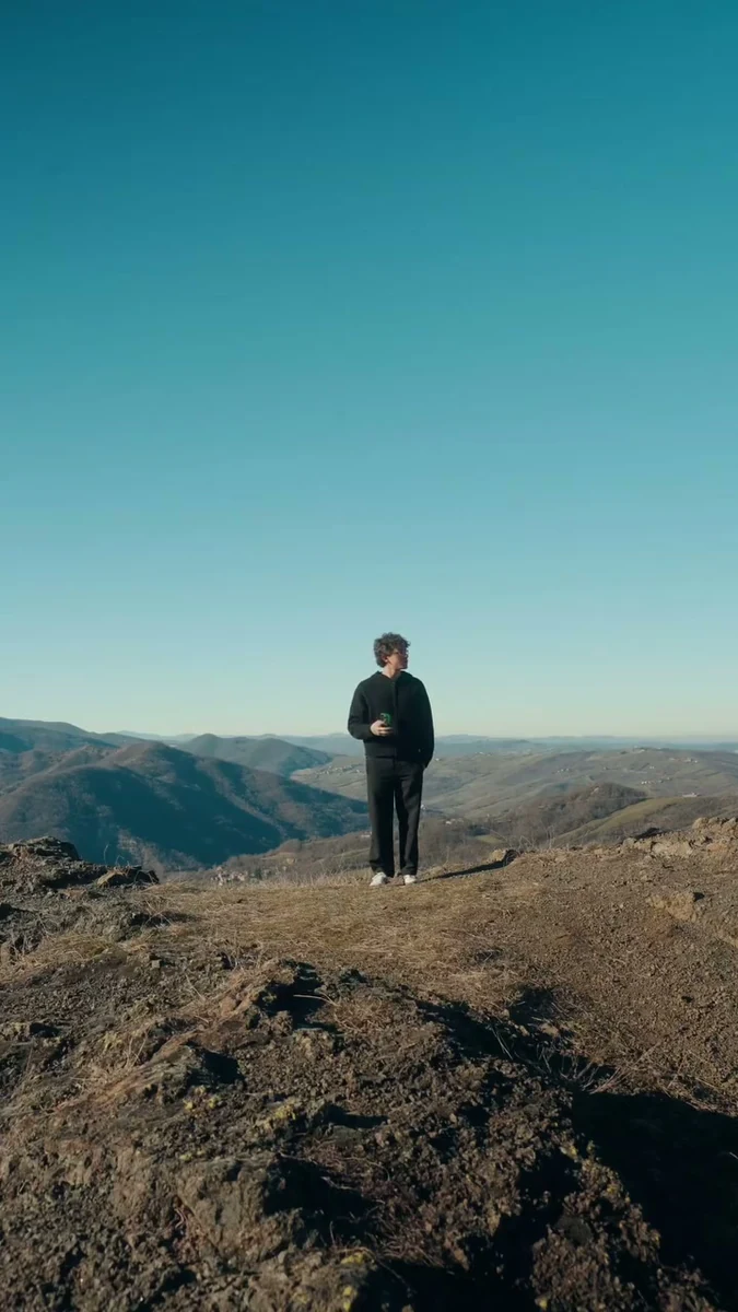 Mattia standing alone in a rocky landscape