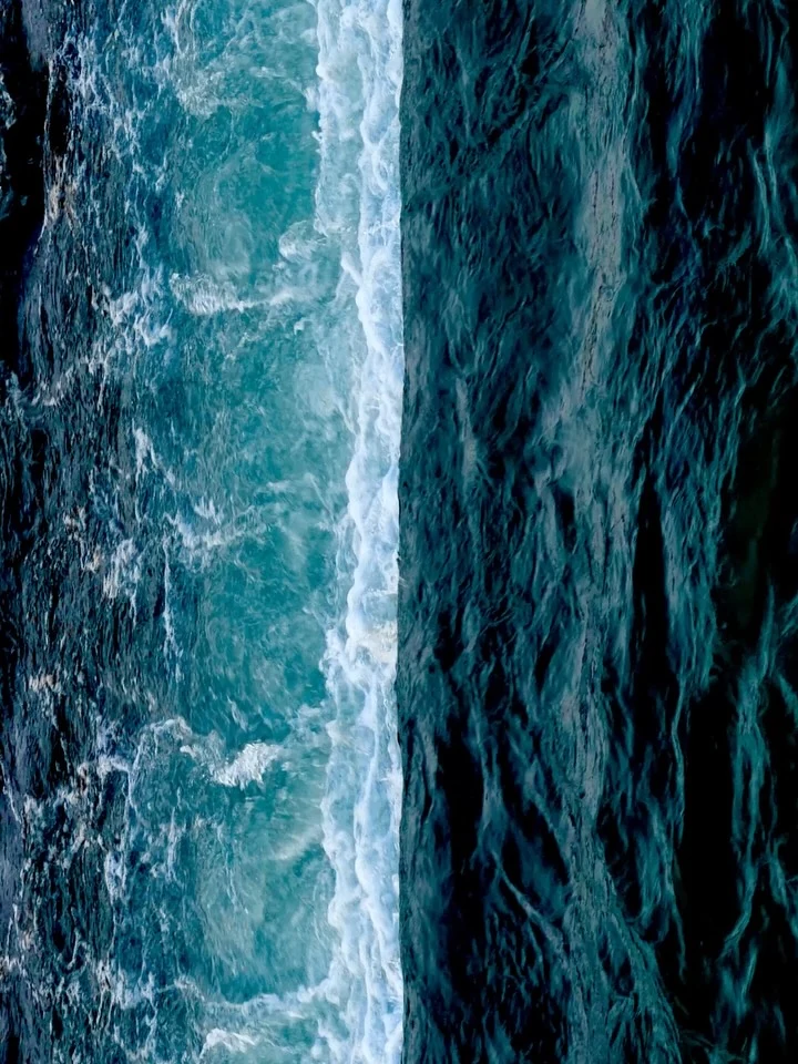 Sunlight and shadows on moving blue water