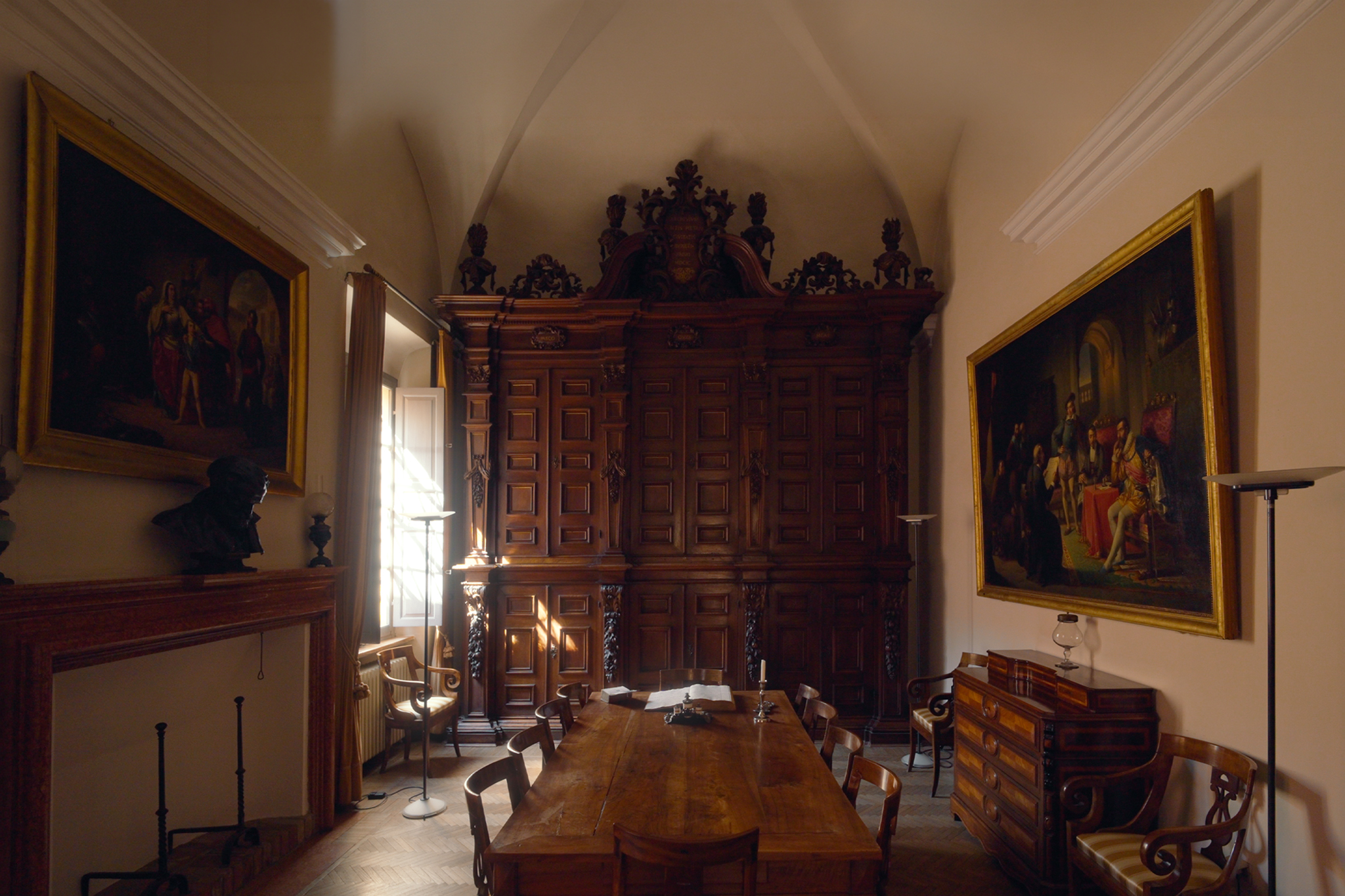 The grand baroque room inside the palazzo, with large carved wooden cabinet and paintings